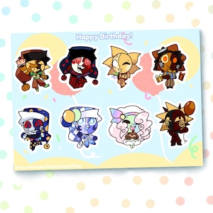 May include: A sheet of colourful stickers featuring cartoon characters with various designs. The stickers include characters with sun, moon, and gift box themes. The text "Happy Birthday!" is at the top. The background is light blue with polka dots.