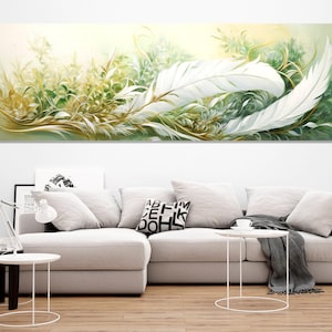 May include: Abstract painting of white feathers on a green and gold background. The painting is framed and hanging on a white wall above a white sofa.