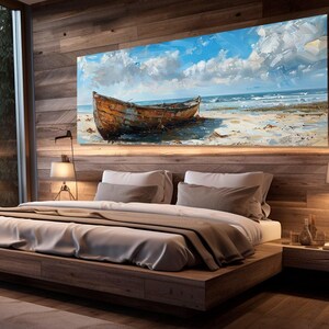 May include: A wooden bed frame with a white duvet and brown throw pillows. A large painting of a wooden boat on a beach with blue sky and clouds hangs above the bed.