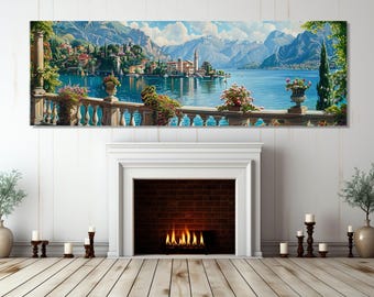 Puede incluir: Una pintura de paisaje panorámica que representa un pintoresco pueblo italiano enclavado junto a un tranquilo lago. La escena presenta encantadores edificios, exuberante vegetación y un cielo azul claro. La pintura está enmarcada y se exhibe sobre una chimenea.