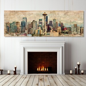 May include: A panoramic canvas print of the Seattle skyline, featuring the Space Needle and various skyscrapers. The artwork has a vintage, textured appearance with muted tones of blue, brown, and beige. The print is displayed above a white fireplace.