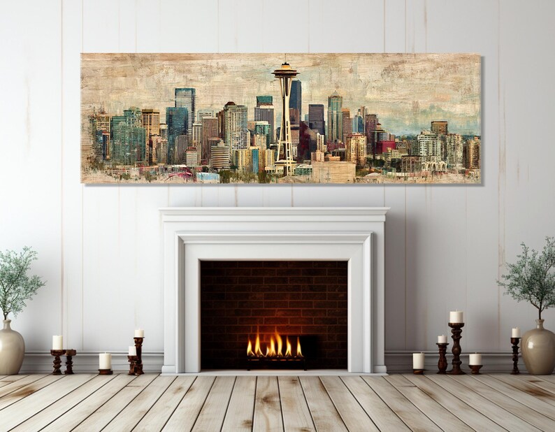 May include: A panoramic canvas print of the Seattle skyline, featuring the Space Needle and various skyscrapers. The artwork has a vintage, textured appearance with muted tones of blue, brown, and beige. The print is displayed above a white fireplace.