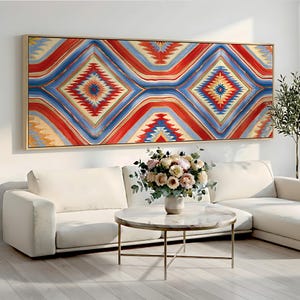 May include: A large rectangular wall art piece featuring a repeating geometric diamond pattern in vibrant shades of red, blue, yellow, and white, enclosed within a thin light-colored wooden frame and displayed horizontally on a plain wall.
