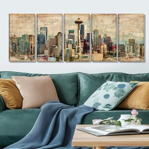 May include: Five-panel wall art featuring a vintage-style depiction of a city skyline, including the Space Needle. The artwork showcases a muted color palette with shades of beige, brown, and blue, creating a textured, aged appearance. The panels are displayed above a teal sofa.