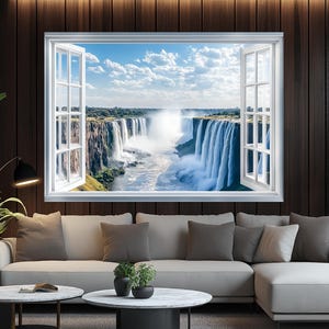 May include: A framed wall art piece depicting a scenic waterfall view through an open white window. The artwork is set against a dark wood-paneled wall, with a modern sofa and coffee tables in the foreground. Green plants and a black lamp add to the decor.