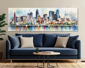 Puede incluir: Una pintura de acuarela de un horizonte urbano con edificios altos, árboles y una masa de agua reflectante. La obra de arte presenta una variedad de colores, incluyendo azules, naranjas y verdes. La pintura se exhibe sobre un sofá azul con cojines beige.
