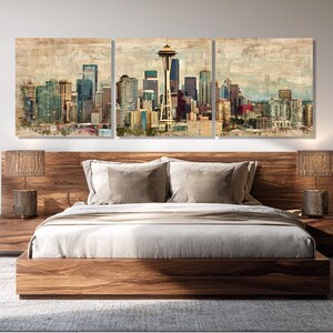 May include: A three-panel wall art set depicting a cityscape with a prominent Space Needle. The artwork features a vintage, textured effect with muted colors of blue, green, and brown. The art hangs above a wooden bed frame with matching nightstands and lamps.