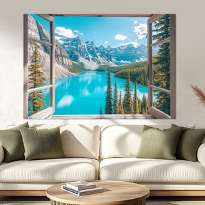 May include: A framed print of a window view of a mountain lake with a blue sky and green trees. The window is open and the view is framed by the window.