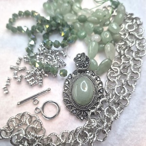 May include: A set of three ceramic nesting bowls in shades of blue, green, and white. The bowls feature a speckled glaze and a simple, modern design. The largest bowl is approximately 6 inches in diameter.