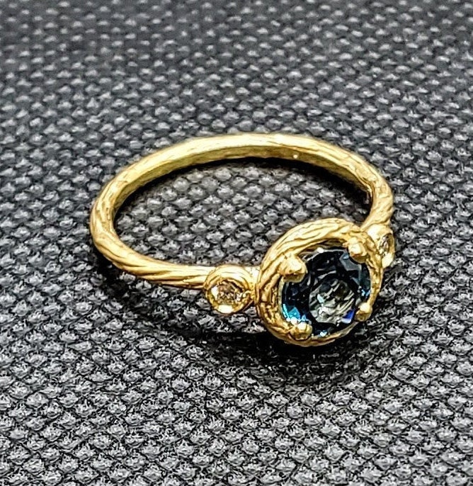 14k solid yellow gold textured ring with 0.05 ct. SI1 clarity, G color natural brilliant diamonds & 1.00 ct. natural AAA London blue topaz.