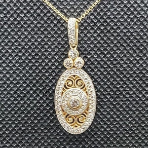 Wisiorek w stylu vintage wykonany z 14-karatowego żółtego złota o czystości 0,56 ct. SI1 i naturalnych brylantach barwy G.
