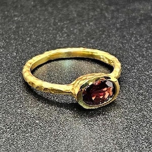 14k solid yellow gold hammered ring with 1.00 ct. 7x5 mm oval shape natural AAA garnet.