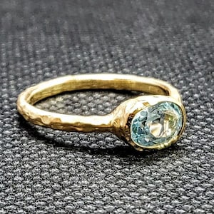14k solid yellow gold hammered ring with 1.00 ct. 7x5 mm oval shape natural AAA aquamarine.