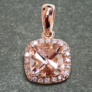 14k solid rose gold pendant with 0.18ct. SI1, G color natural brilliant diamonds and 1.70ct. AAA natural morganite. Includes a 16" 14k chain