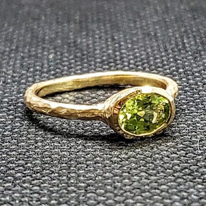 14k solid yellow gold hammered ring with 0.71 ct. 7x5 mm oval shape natural AAA peridot.