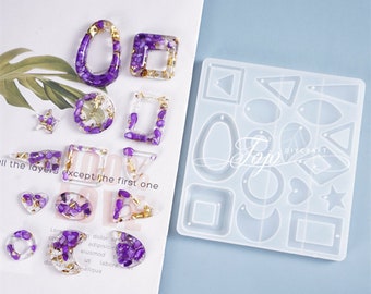 May include: A clear silicone mold with multiple shapes for making earrings. The mold includes shapes like circles, ovals, squares, triangles, stars, and a crescent moon. The mold is shown next to several finished resin earrings with purple and gold accents.