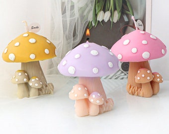 May include: Three mushroom-shaped candles with white polka dots. The candles are yellow, purple, and pink. Each candle has a small wick and three smaller mushrooms at the base.