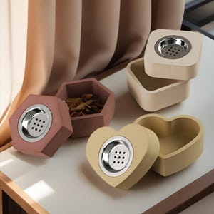 May include: Four decorative containers with different shapes and colors. The containers are made of a light brown material and have a metal insert with holes. The containers are perfect for storing small items, such as jewelry or incense.