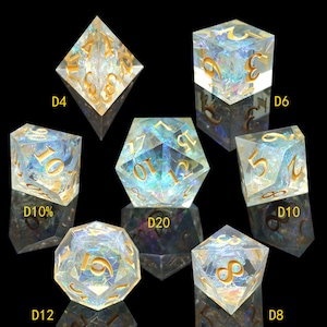 May include: Set of iridescent dice with gold numbers. The dice are in various shapes, including a four-sided die, a six-sided die, a ten-sided die, a twelve-sided die, a twenty-sided die, and an eight-sided die.