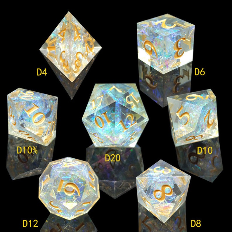 May include: Set of iridescent dice with gold numbers. The dice are in various shapes, including a four-sided die, a six-sided die, a ten-sided die, a twelve-sided die, a twenty-sided die, and an eight-sided die.