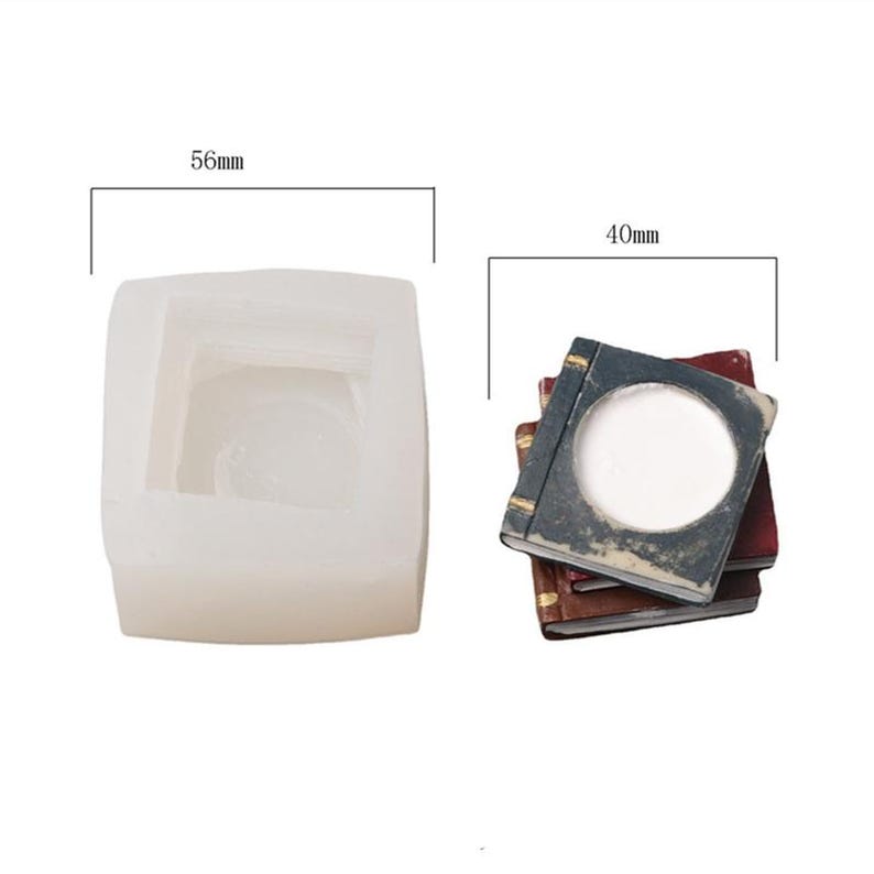 May include: A white silicone mold for making a stack of three books. The mold is 5.6 inches wide and 4 inches tall. The mold is designed to create a stack of books with a round opening in the top book.