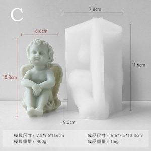 May include: White silicone mould for making a cherub figurine. The mould is 7.8 cm tall, 9.5 cm wide, and 11.6 cm deep. The finished product will be 6.6 cm tall, 7.5 cm wide, and 10.3 cm deep.