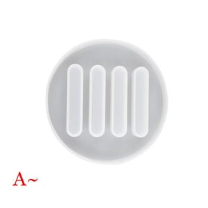 May include: White silicone mold with four rectangular cavities. The mold is designed for making resin crafts.