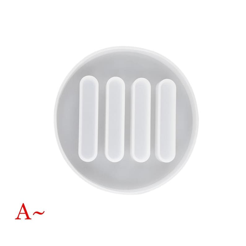 May include: White silicone mold with four rectangular cavities. The mold is designed for making resin crafts.