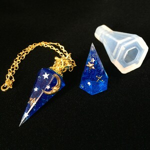 May include: A gold chain necklace with a blue and gold star and crescent moon pendant. The pendant is shaped like a pyramid and is made of resin. A clear silicone mold is also included.