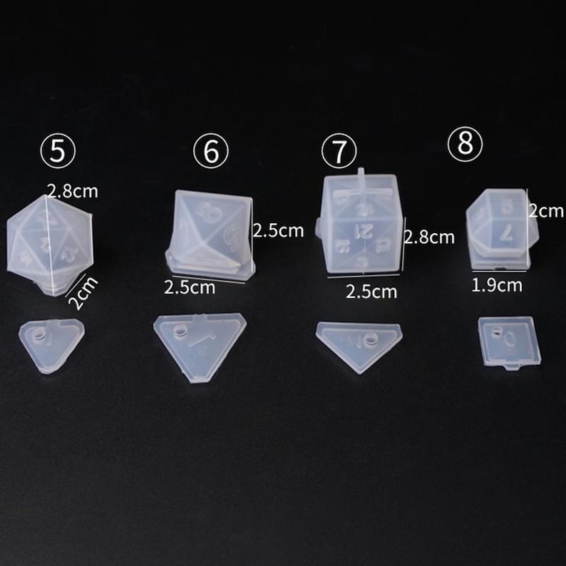 May include: Set of five clear silicone molds for making dice. The molds are numbered 5 through 8 and measure 2.5 cm to 2.8 cm in size.