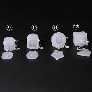 May include: Set of six clear silicone molds for making dice. The molds are numbered 9 through 12 and are different shapes and sizes. The molds are 1.5 to 2.5 inches in diameter.