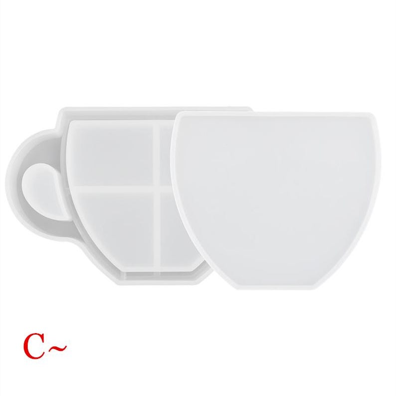 May include: White silicone mold shaped like a coffee cup with a handle. The mold is divided into four sections.