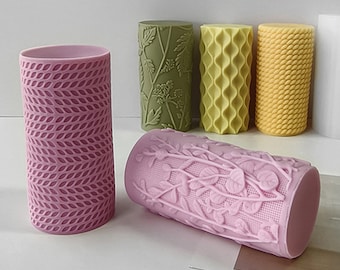 May include: Five different textured silicone rollers for crafting, in shades of green, yellow, and pink. The rollers are cylindrical and have various embossed patterns.