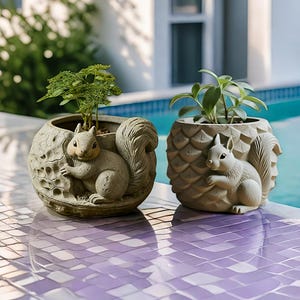 May include: Two round, light-colored planters featuring sculpted squirrel figures on the exterior. The left planter has a textured, rock-like surface, while the right planter displays a geometric, pineapple-inspired pattern. Both contain small green plants.