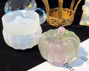 May include: A clear, iridescent pumpkin-shaped resin mold with a glitter finish. The mold is sitting on a white surface.