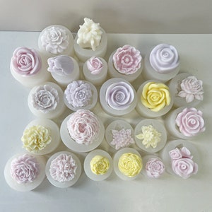 May include: A collection of 19 silicone molds featuring various flower designs. The molds are white and feature a variety of flower shapes, including roses, peonies, and daisies. The molds are perfect for creating beautiful and unique floral decorations for cakes, cupcakes, and other desserts.