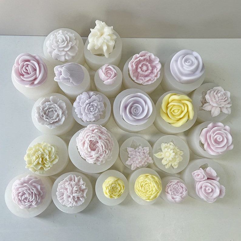 May include: A collection of 19 silicone molds featuring various flower designs. The molds are white and feature a variety of flower shapes, including roses, peonies, and daisies. The molds are perfect for creating beautiful and unique floral decorations for cakes, cupcakes, and other desserts.