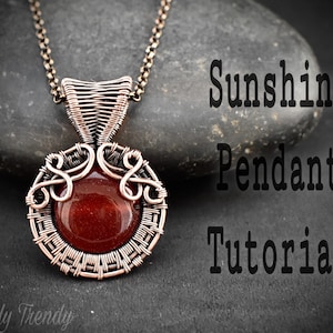 May include: A copper wire wrapped pendant with a red gemstone in the centre. The pendant is hanging from a copper chain. The text "Sunshine Pendant Tutorial" is written in black text on a grey background.