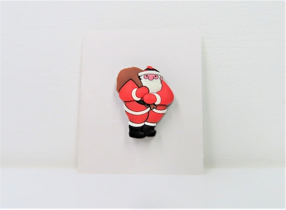 A Raymond Briggs Father Christmas pin.