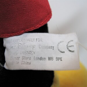 May include: White tag with black text that reads "Licensed Company for Disney Pixar Company by Disney Disney Store London W6 9PE Made in China" and a CE mark.
