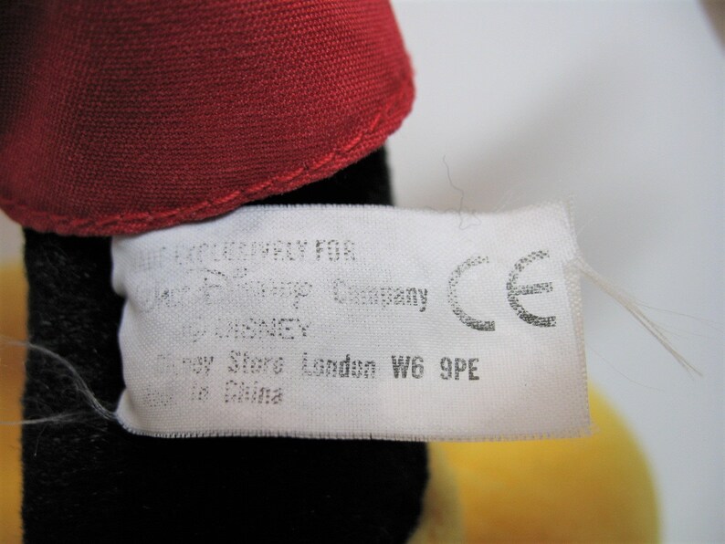 May include: White tag with black text that reads "Licensed Company for Disney Pixar Company by Disney Disney Store London W6 9PE Made in China" and a CE mark.