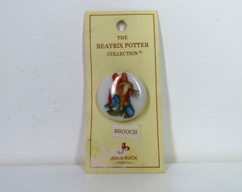 A vintage 1992 Beatrix Potter Peter Rabbit with Carrot button shaped brooch. By John Buck,  Lovely rare find!