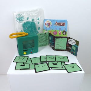 A BOM changing faces game keyring, complete.  Adventure Time toy.