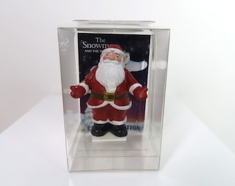 A Raymond Briggs Father Christmas cake topper.  The Snowman cake topper.