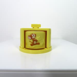 A vintage 1997 Tom and Jerry spinning cheese toy.