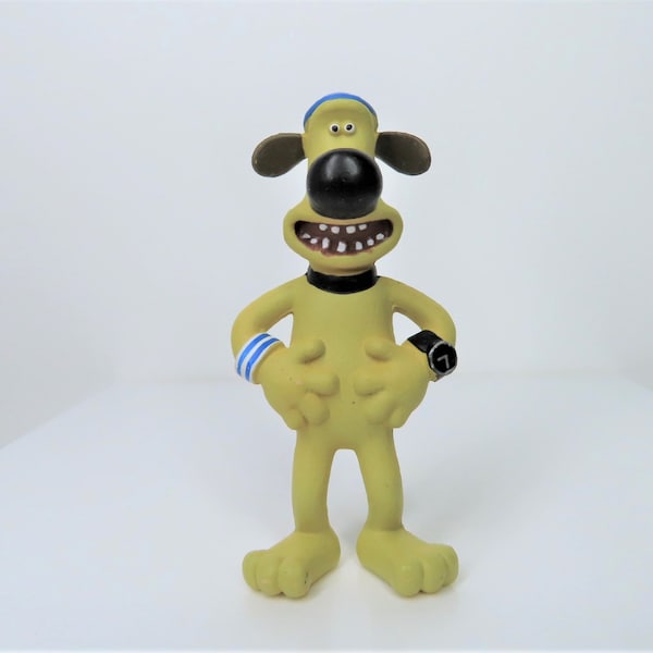 Ein Bitzer Hund Kunststoff Figur von Comansi, Shaun das Schaf Film Spielzeug.