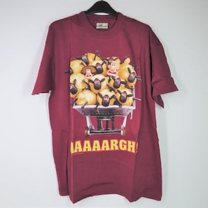 A vintage 1990s Wallace and Gromit burgundy T-Shirt.  Featuring Wallace, Wendolene and wool shop sheep.  In original packaging.