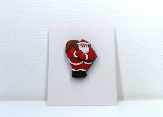 A Raymond Briggs Father Christmas pin.