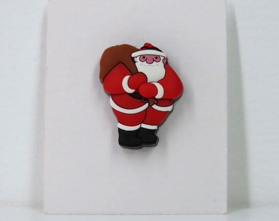 A vintage Raymond Briggs Father Christmas pin badge.