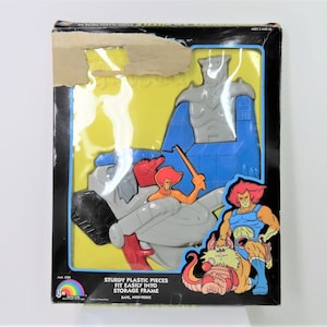 A vintage 1985 Thundercats plastic puzzle with storage frame.